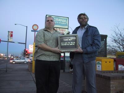 photo of programmers holding monitor on street corner